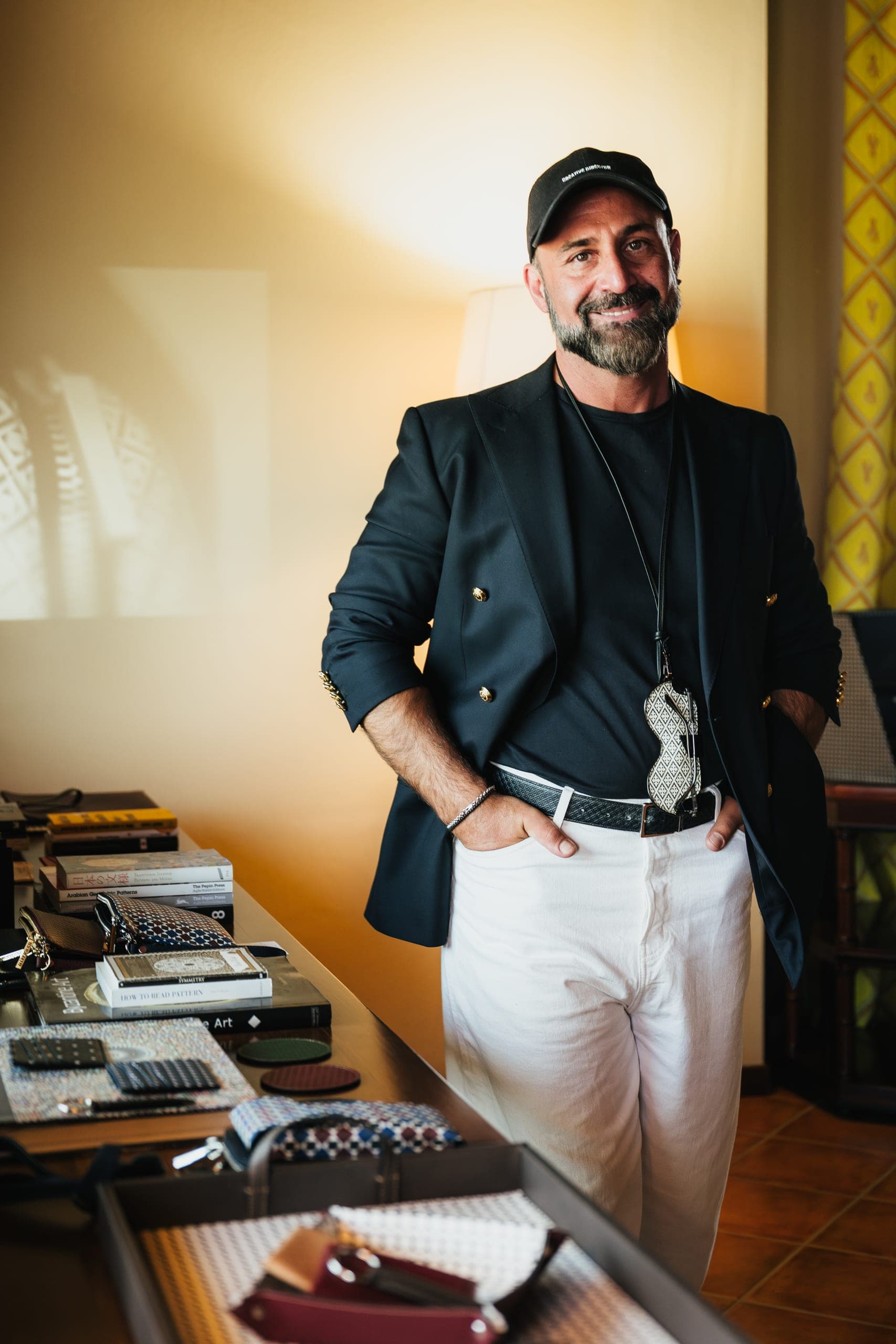 A member of the team standing at a desk with an old typewriter, smiling at the camera